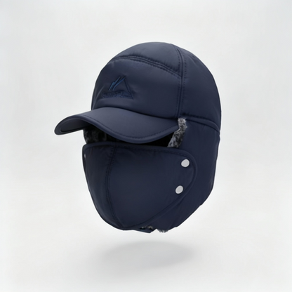 Navy blue winter cap with ear flaps on a light gray background