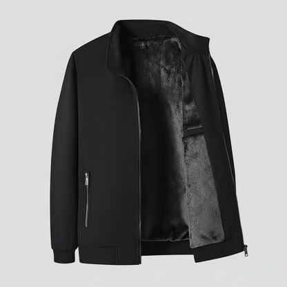 Black jacket with gray lining displayed against a snowy forest background